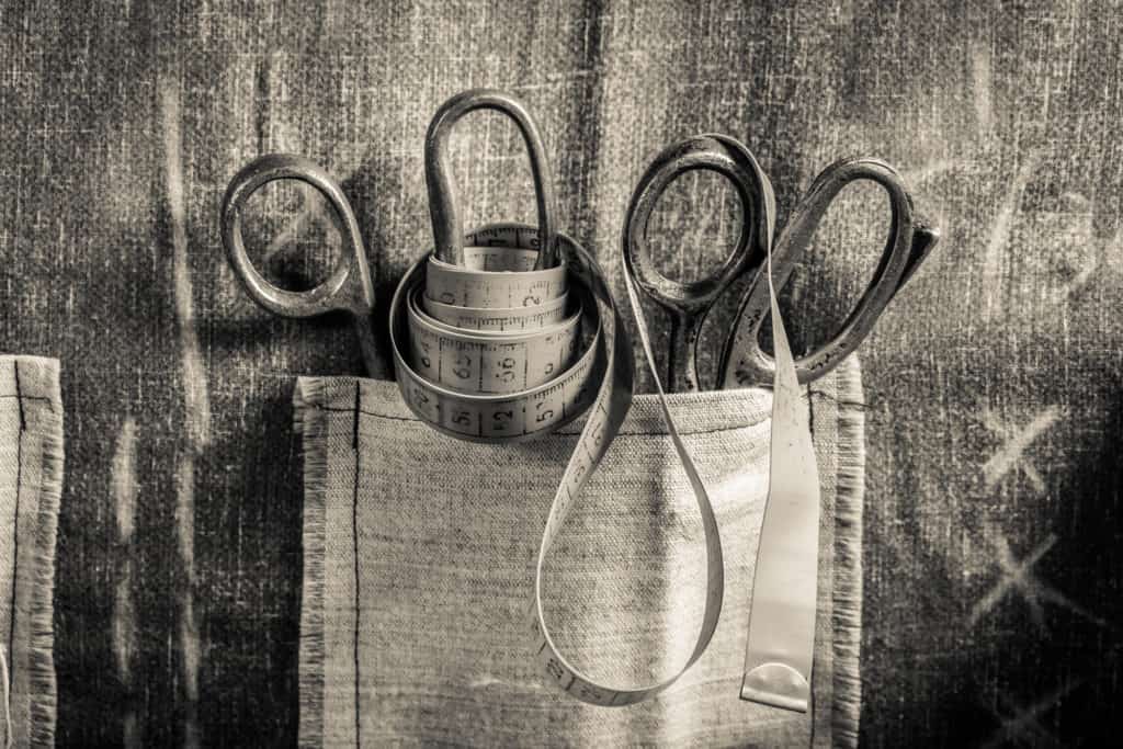 Photo of old scissors and measuring tape in the pocket of a bespoke tailor in Thailand